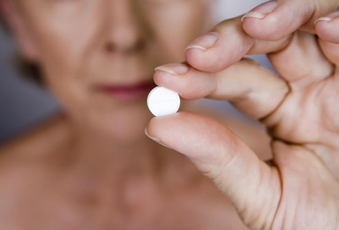 photolibrary rf photo of woman holding pill